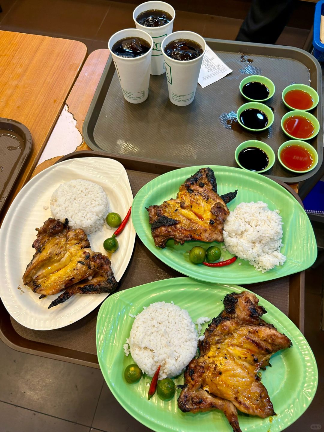 Boracay-Grilled chicken and rice at Mang Inasa restaurant in the Philippines, topped with lime