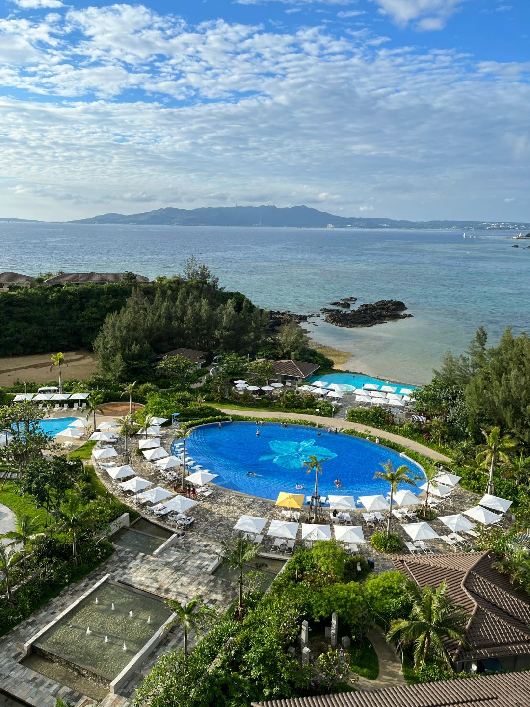 Okinawa-Halekulani Okinawa, a luxury resort in Okinawa, Japan, with staff bending over and smiling