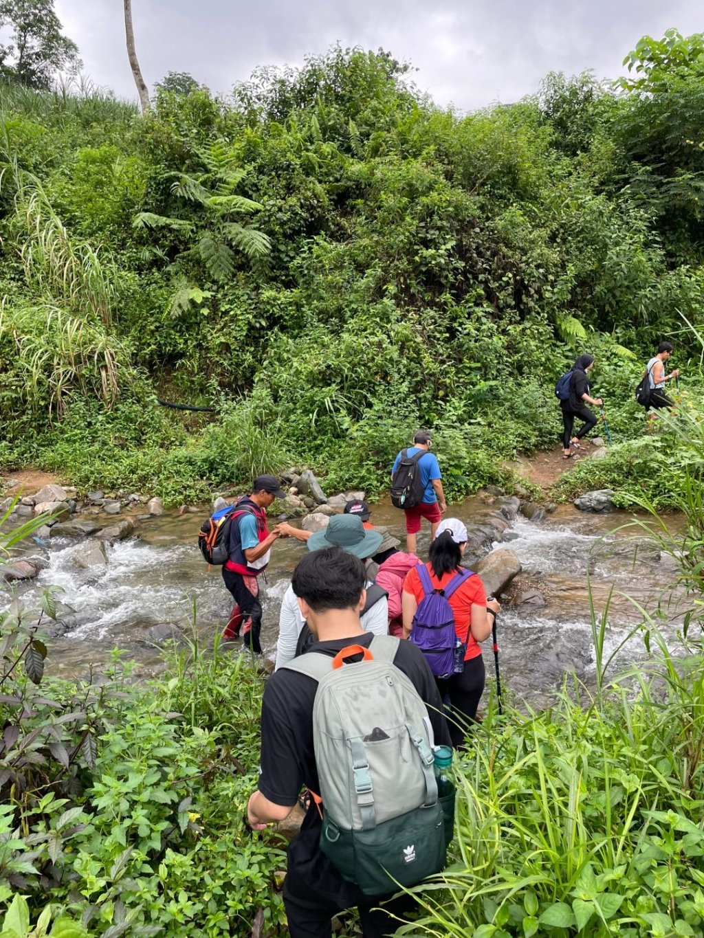 Jakarta-Hiking at Sentul Rice Field Waterfall in Jakarta, with traditional costumes hanging on bamboo poles