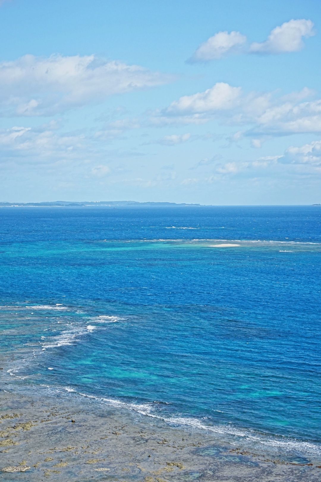 Okinawa-Beautiful Chinian Cape with turbulent waves and the distant sheep