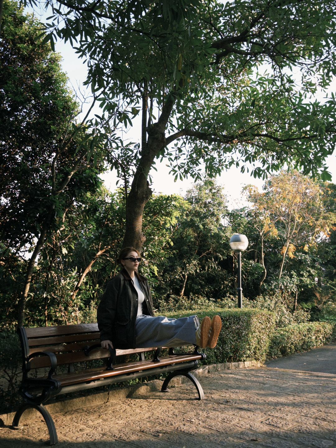 Macao-At Macau's Erlonghou Park, locals sit on the grass and have a picnic in groups of 2 or 3