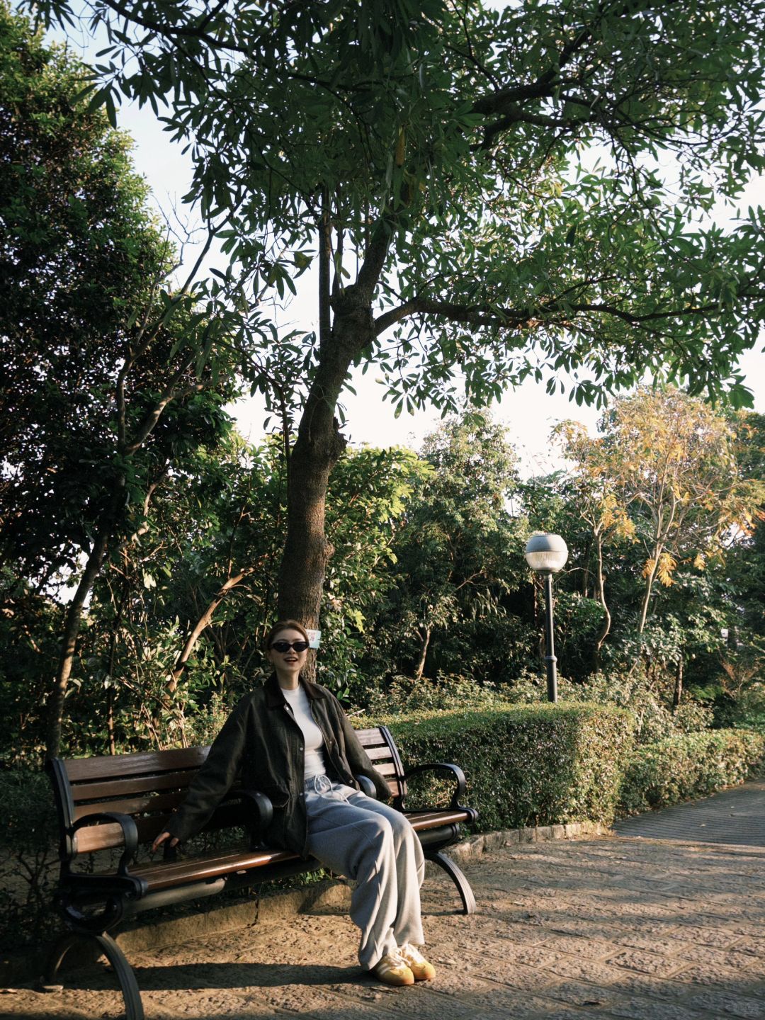 Macao-At Macau's Erlonghou Park, locals sit on the grass and have a picnic in groups of 2 or 3