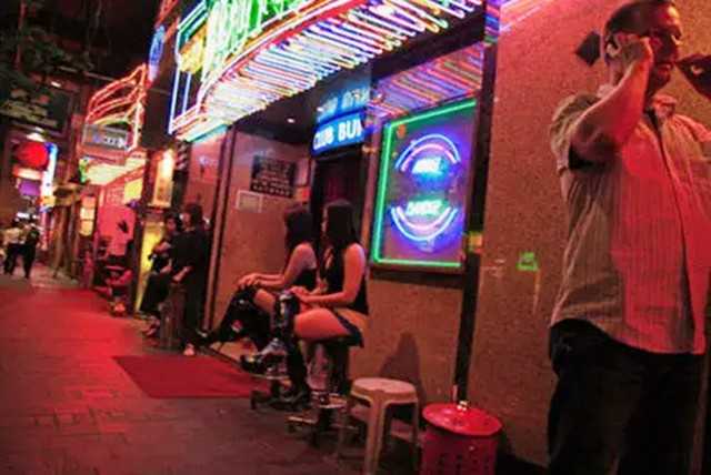 Hong kong-The history and present of Hong Kong's Wan Chai "red light district", with nightclubs and neon lights all over the "brothels"