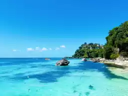 Diniwid Beach, a cliff at the end of the white beach, where locals will help you take photos