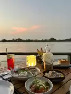 The Deck?, a sunset restaurant on the riverside of Ho Chi Minh City, recommends lemon-marinated sashimi and oysters