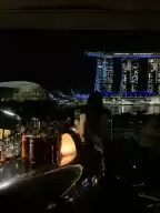 The night view of smoke & mirrors bar facing marina bay is so beautiful