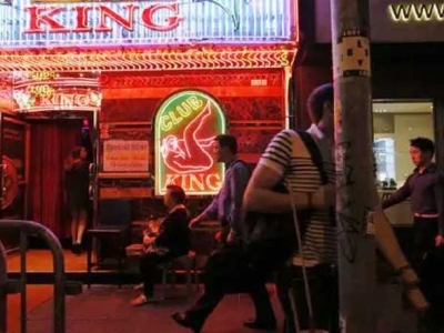 The history and present of Hong Kong's Wan Chai "red light district", with nightclubs and neon lights all over the "brothels"